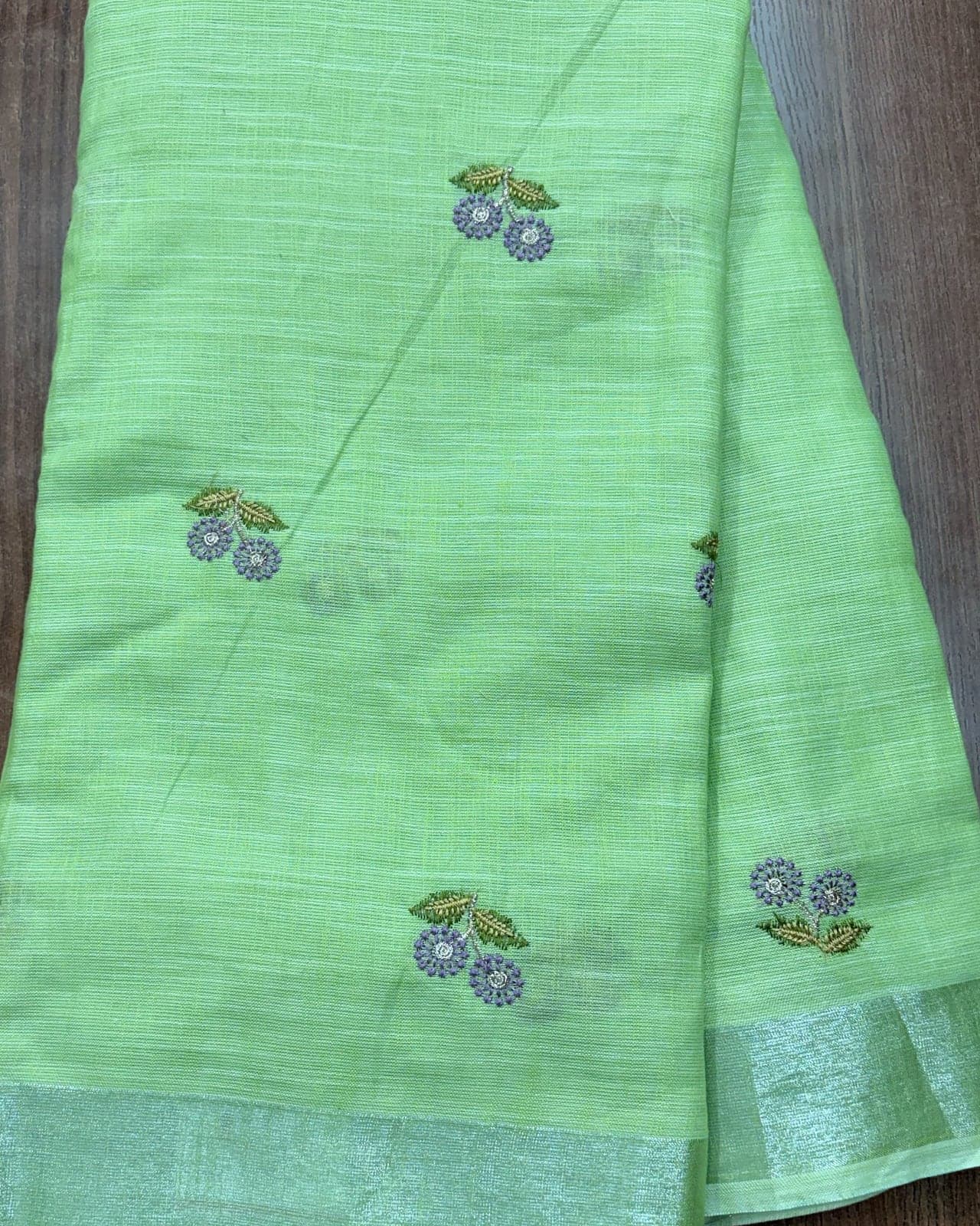 Pista green linen saree with silver zari border