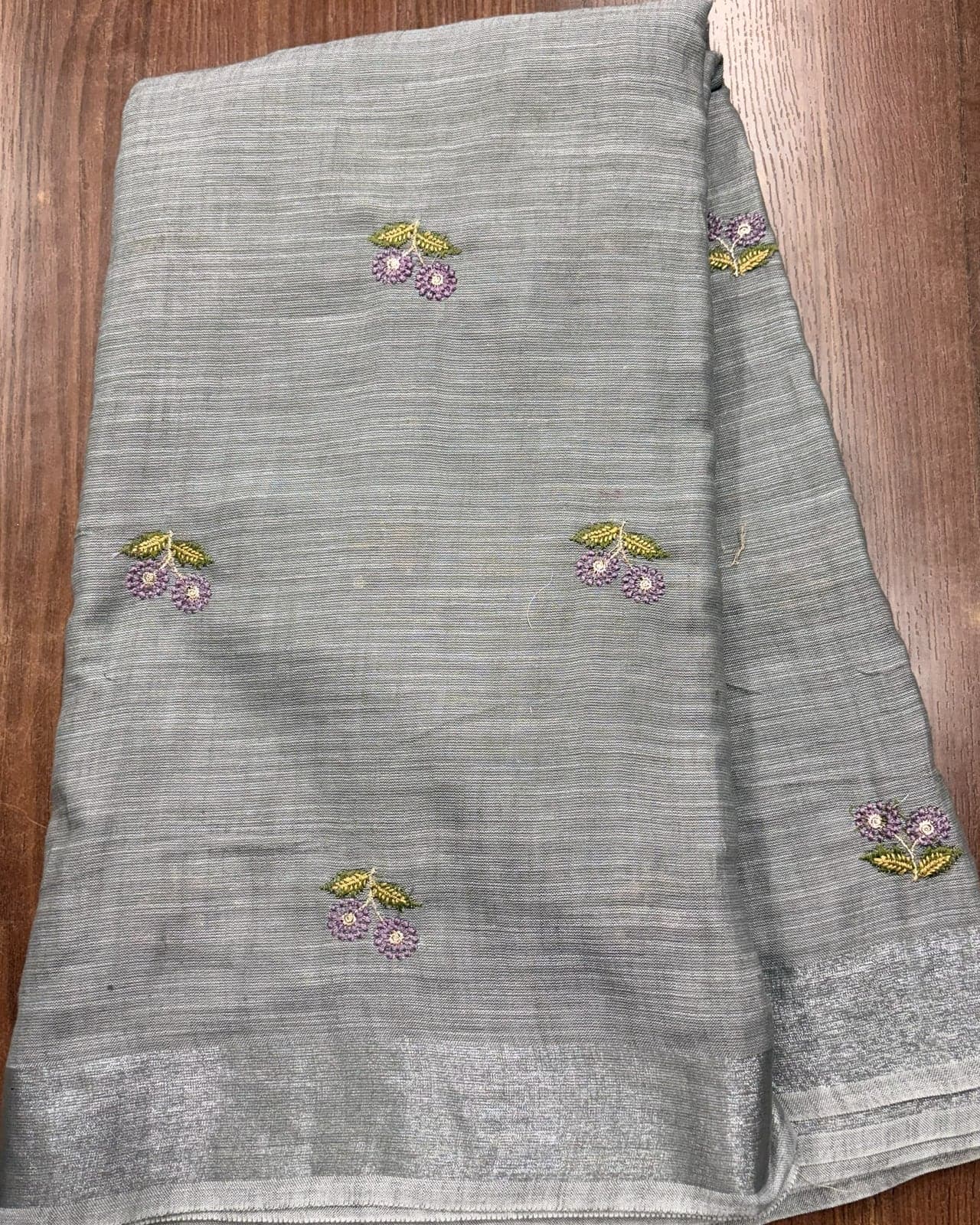 Stone grey linen saree with silver zari border